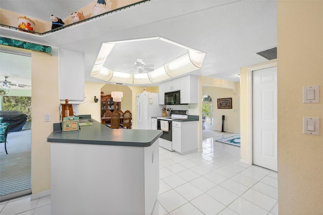 4461 La France Ave, North Port, FL 34286 - kitchen with electric range oven, black microwave, ceiling fan, dark countertops, and light tile patterned floors