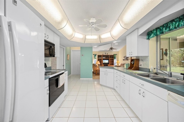 4461 La France Ave, North Port, FL 34286 - kitchen with white appliances, a ceiling fan, a sink, light tile patterned flooring, and white cabinets