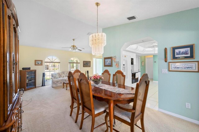 4461 La France Ave, North Port, FL 34286 - dining room featuring light carpet, a ceiling fan, a chandelier, baseboards, and vaulted ceiling