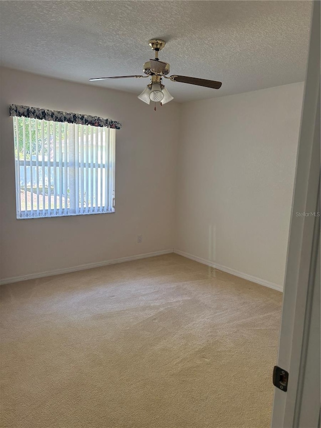 4461 La France Ave, North Port, FL 34286 - carpeted spare room with a textured ceiling, a ceiling fan, and baseboards