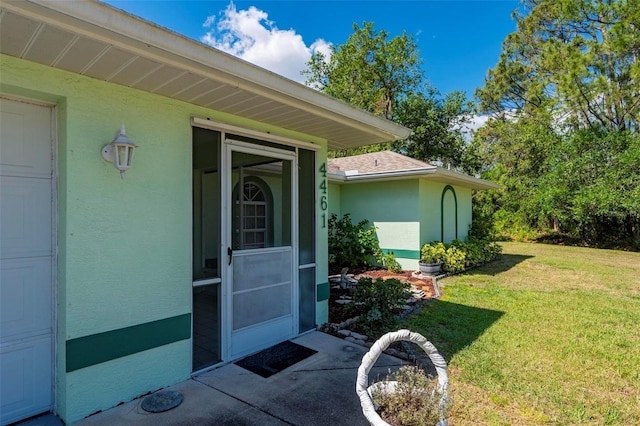 4461 La France Ave, North Port, FL 34286 - doorway to property featuring a yard and stucco siding