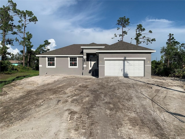 139 Hardee Way, Rotonda West, FL 33947 - ranch-style home with stucco siding, a garage, and a shingled roof