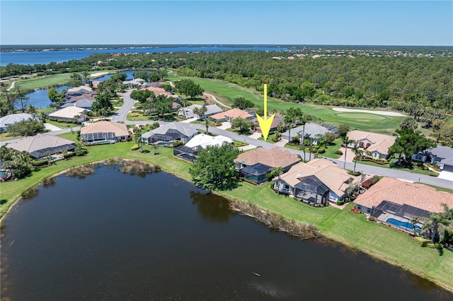 birds eye view of property with a residential view, a water view, and view of golf course