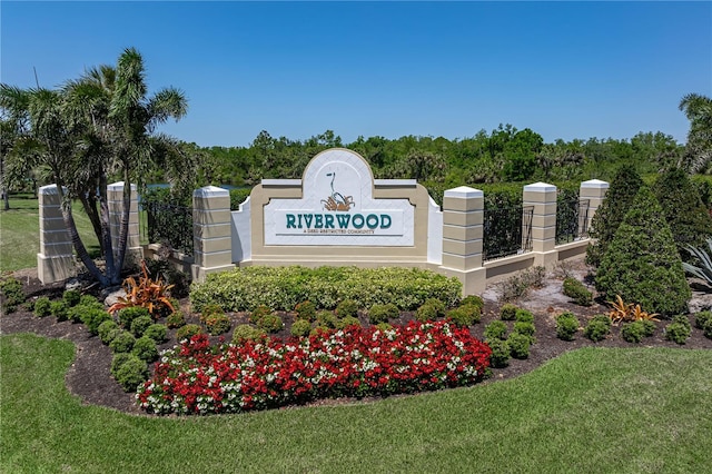 community / neighborhood sign featuring a yard