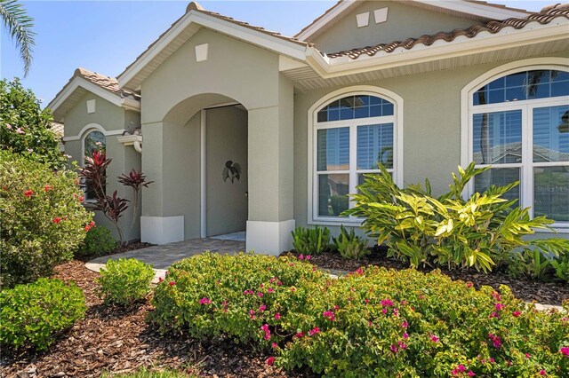 view of front of home with stucco siding and a tile roof