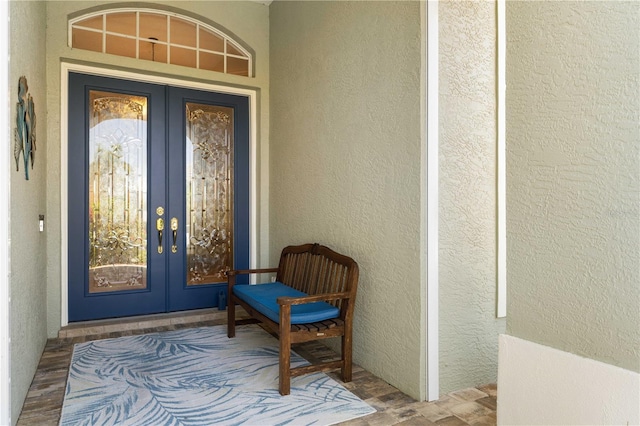 entrance to property with french doors and stucco siding