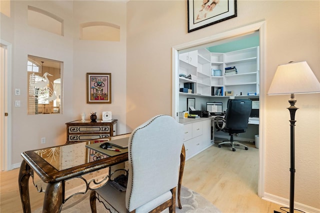 office featuring baseboards and light wood-style flooring