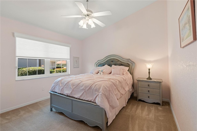 carpeted bedroom featuring ceiling fan, vaulted ceiling, and baseboards