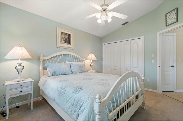 carpeted bedroom with lofted ceiling, visible vents, ceiling fan, baseboards, and a closet