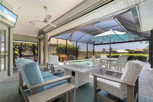 view of patio / terrace featuring a fire pit, glass enclosure, outdoor dining space, a ceiling fan, and a grill