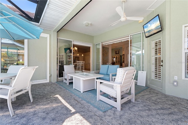 view of patio with an outdoor fire pit and ceiling fan