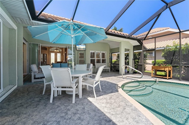 pool with glass enclosure, outdoor dining area, and a patio area