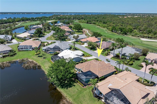 drone / aerial view with a water view, a residential view, and view of golf course