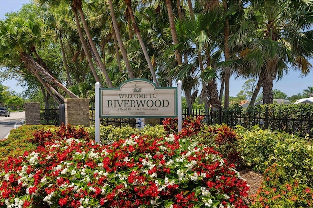 community / neighborhood sign with fence