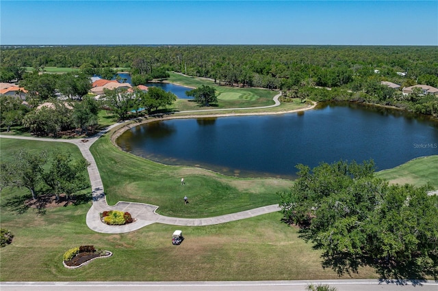 aerial view featuring a wooded view, golf course view, and a water view