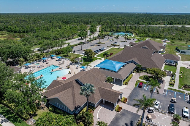 drone / aerial view featuring a wooded view