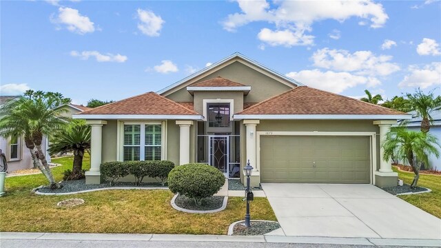 single story home featuring stucco siding, concrete driveway, a shingled roof, and a garage