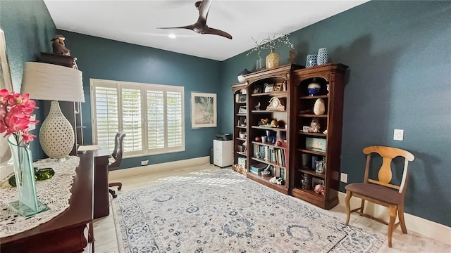 office space with baseboards, a ceiling fan, and wood finished floors