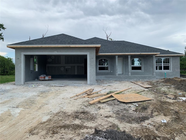 7 Pine Valley Ct, Rotonda West, FL 33947 - view of front facade featuring an attached garage, roof with shingles, and stucco siding