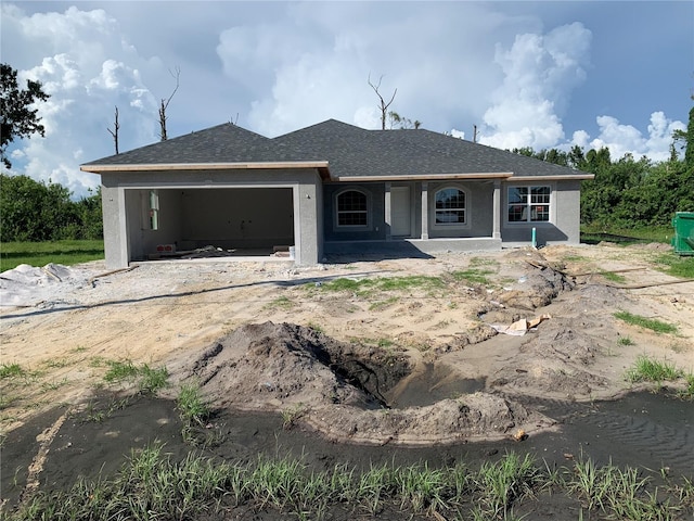 7 Pine Valley Ct, Rotonda West, FL 33947 - view of front facade with an attached garage, stucco siding, roof with shingles, and covered porch