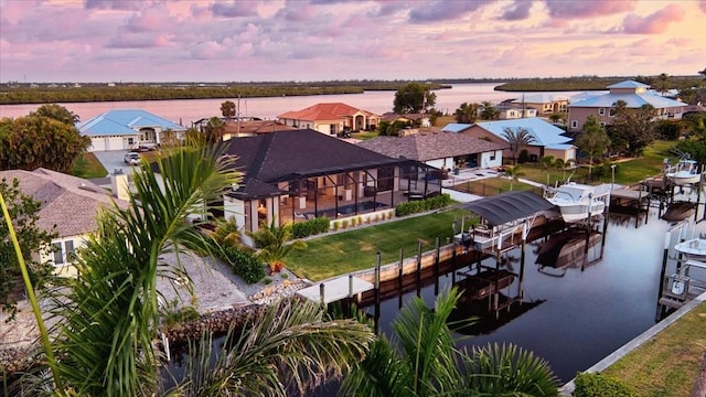 birds eye view of property featuring a residential view and a water view
