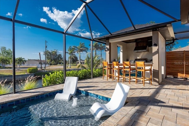 exterior space featuring a patio, a lanai, and outdoor dry bar