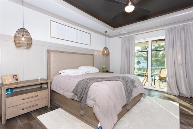 bedroom featuring access to outside, dark wood-style flooring, and ceiling fan