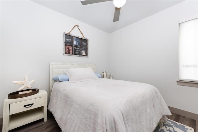 bedroom featuring a ceiling fan, baseboards, and wood finished floors