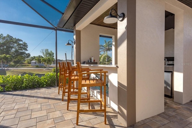 view of patio / terrace featuring a lanai