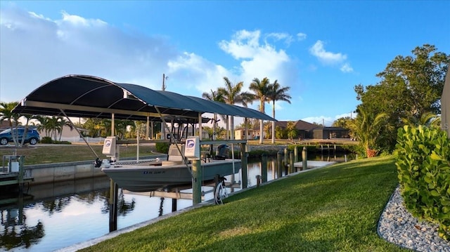 dock area featuring boat lift, a water view, and a yard