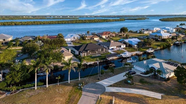 birds eye view of property featuring a water view and a residential view