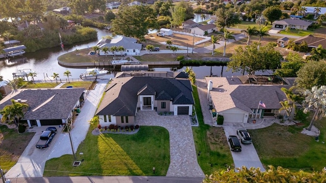 drone / aerial view with a water view and a residential view