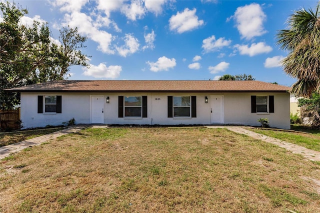 1665 Florence Ave Unit B, Englewood, FL 34223 - ranch-style house with fence, a front lawn, and stucco siding