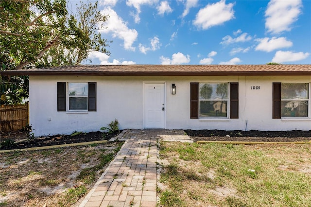 1665 Florence Ave Unit B, Englewood, FL 34223 - view of front facade with stucco siding and fence