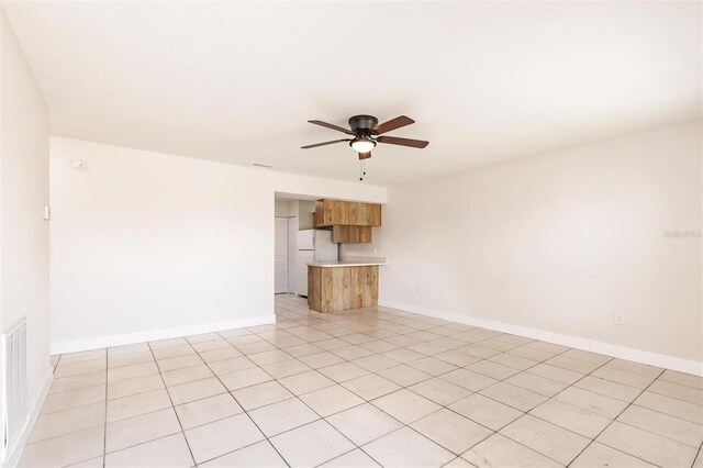 1665 Florence Ave Unit B, Englewood, FL 34223 - unfurnished living room featuring ceiling fan, baseboards, light tile patterned flooring, and visible vents