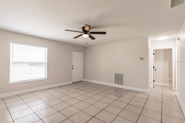 1665 Florence Ave Unit B, Englewood, FL 34223 - unfurnished room with light tile patterned flooring, a textured ceiling, visible vents, and ceiling fan
