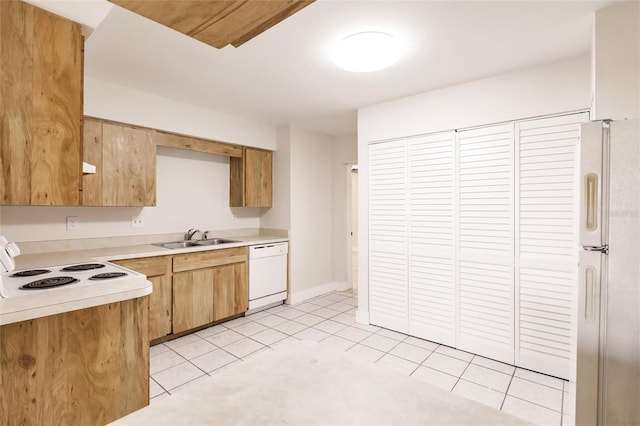 1665 Florence Ave Unit B, Englewood, FL 34223 - kitchen with light countertops, light tile patterned flooring, a sink, and white appliances