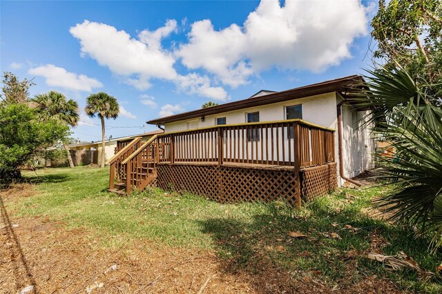 1665 Florence Ave Unit B, Englewood, FL 34223 - back of property with a wooden deck, a yard, stairway, and stucco siding