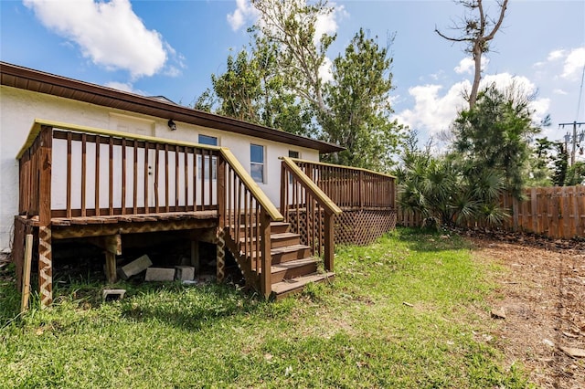1665 Florence Ave Unit B, Englewood, FL 34223 - rear view of property featuring a yard, fence, stucco siding, and a deck
