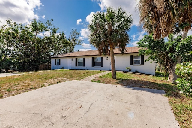 1665 Florence Ave Unit B, Englewood, FL 34223 - ranch-style home featuring stucco siding, a front lawn, and fence
