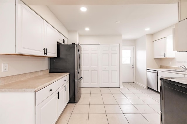 1665 Florence Ave Unit B, Englewood, FL 34223 - kitchen with white cabinets, stainless steel appliances, a sink, light countertops, and light tile patterned floors