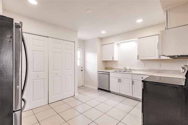 1665 Florence Ave Unit B, Englewood, FL 34223 - kitchen with a sink, recessed lighting, white cabinetry, appliances with stainless steel finishes, and light tile patterned floors