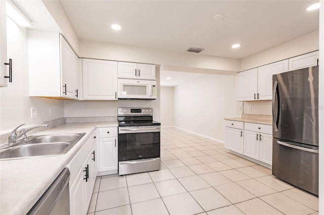 1665 Florence Ave Unit B, Englewood, FL 34223 - kitchen with a sink, stainless steel appliances, light countertops, white cabinets, and visible vents