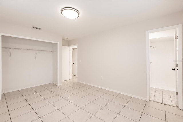 1665 Florence Ave Unit B, Englewood, FL 34223 - unfurnished bedroom featuring light tile patterned floors, baseboards, visible vents, and a closet