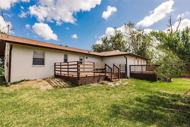 1665 Florence Ave Unit B, Englewood, FL 34223 - back of property featuring a lawn, stucco siding, and a deck