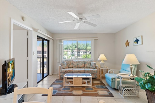 tiled living area featuring a ceiling fan and a textured ceiling