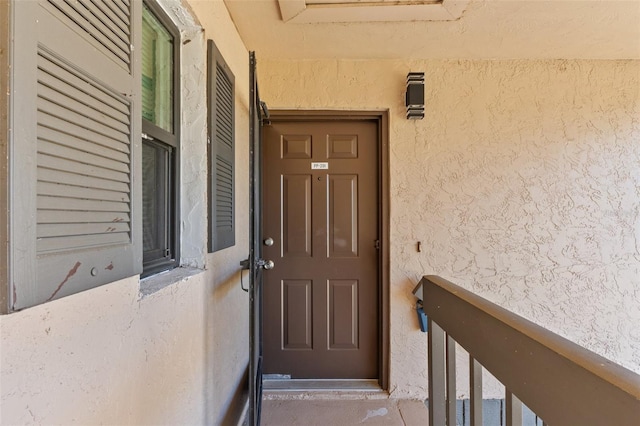 view of exterior entry featuring stucco siding