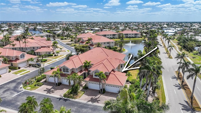 birds eye view of property featuring a water view and a residential view