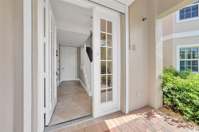 doorway to property with stucco siding
