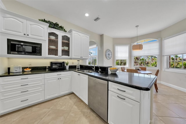 kitchen featuring a sink, a peninsula, a healthy amount of sunlight, dishwasher, and black microwave